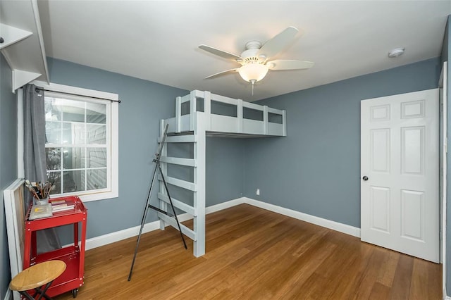 bedroom with wood-type flooring and ceiling fan