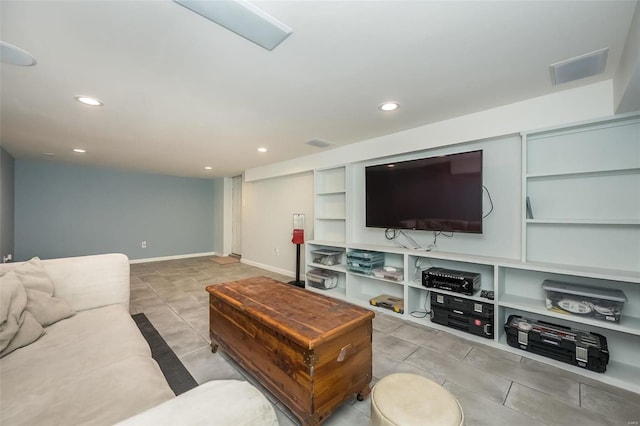 living room with built in features and light tile patterned floors