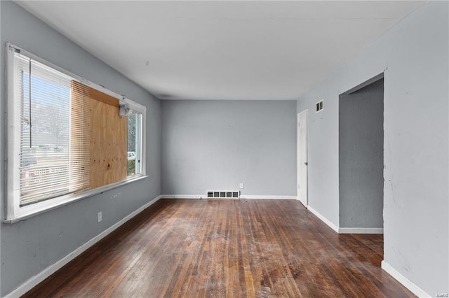 spare room with dark hardwood / wood-style floors