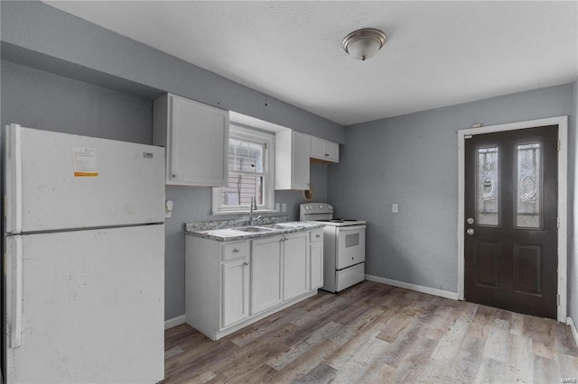 kitchen with white cabinetry, sink, white appliances, and plenty of natural light