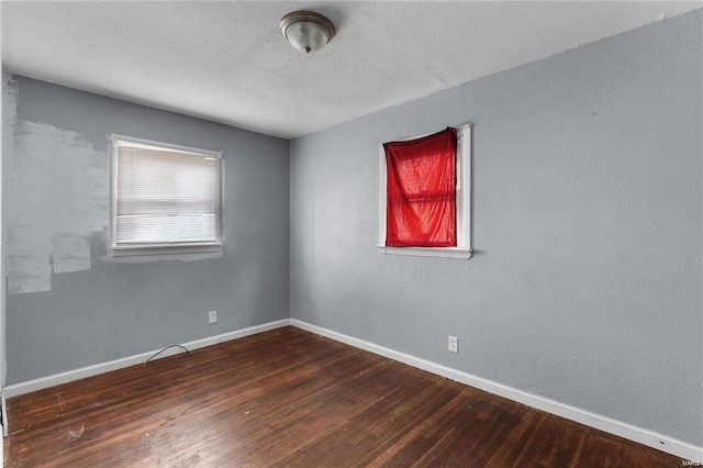 spare room featuring dark hardwood / wood-style flooring