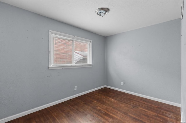 unfurnished room featuring dark hardwood / wood-style flooring