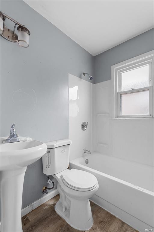 bathroom featuring hardwood / wood-style floors, toilet, and shower / tub combination