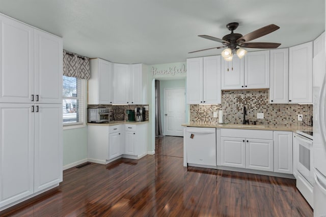 kitchen with dark hardwood / wood-style floors, sink, white cabinets, decorative backsplash, and white appliances