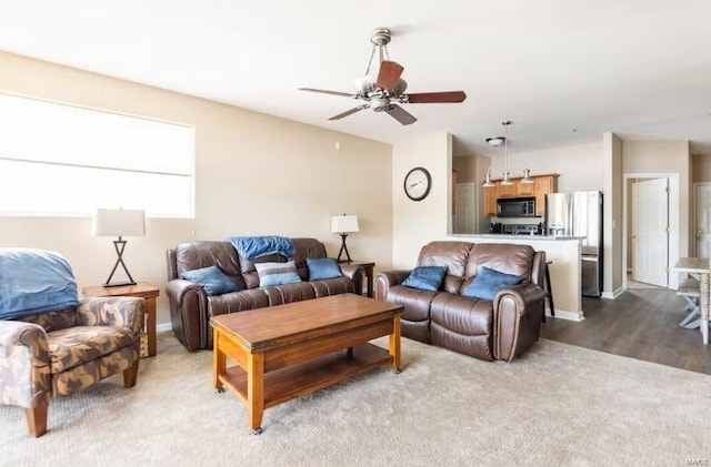 living room with ceiling fan and light wood-type flooring