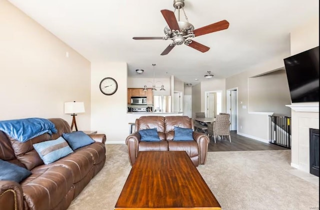 living room featuring light carpet and ceiling fan