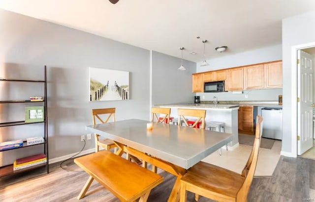 dining space with light hardwood / wood-style flooring