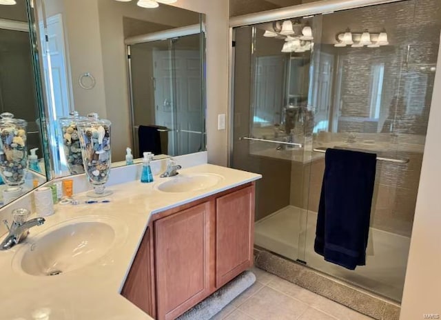 bathroom featuring vanity, a shower with shower door, and tile patterned flooring