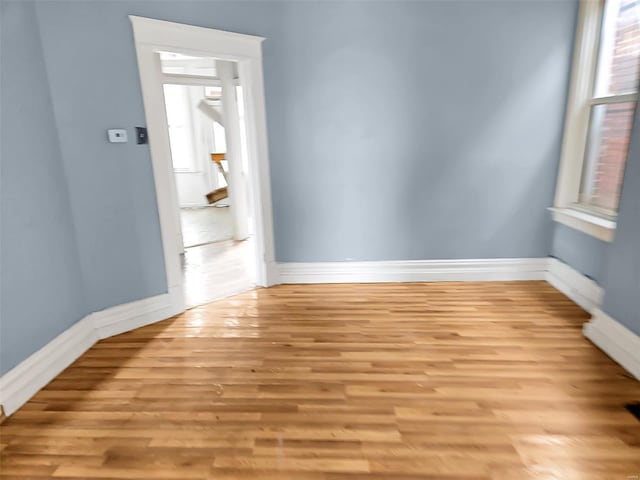 spare room featuring light hardwood / wood-style floors