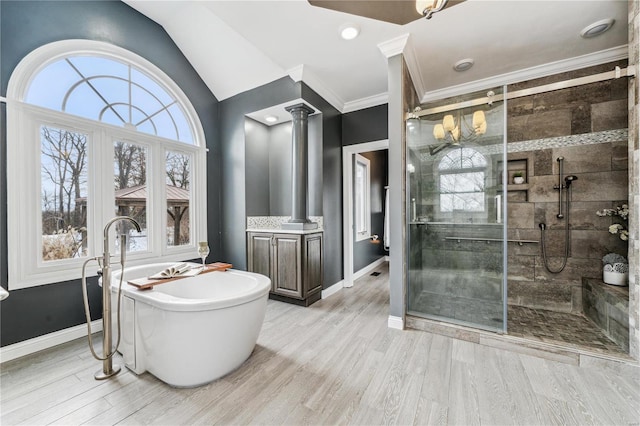 bathroom with hardwood / wood-style floors, decorative columns, vanity, plus walk in shower, and vaulted ceiling