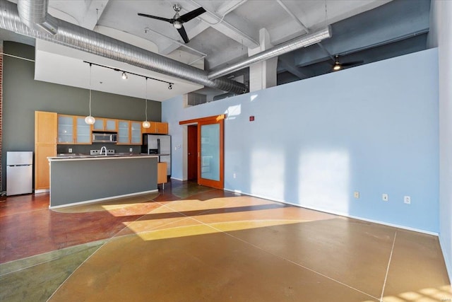 garage with stainless steel refrigerator with ice dispenser, ceiling fan, and white fridge