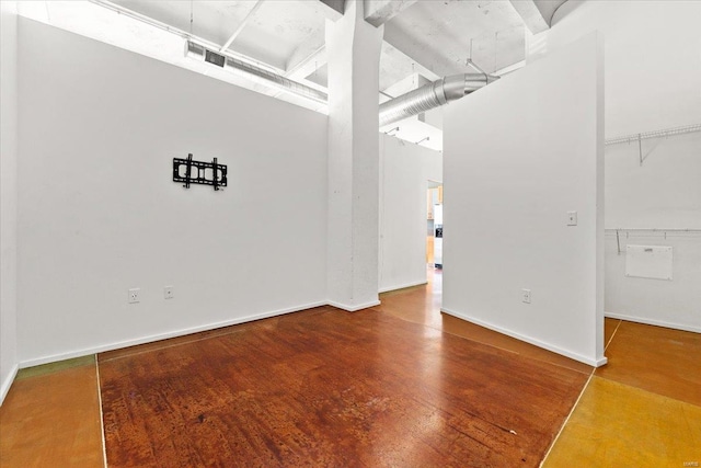 interior space featuring hardwood / wood-style floors and a towering ceiling