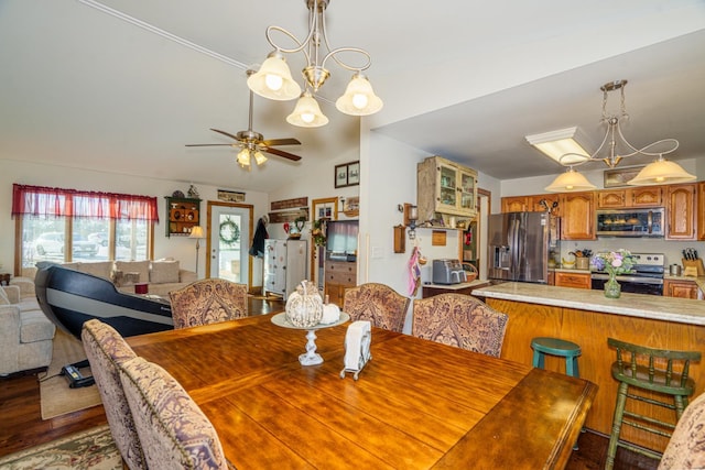 dining area featuring hardwood / wood-style flooring, lofted ceiling, and ceiling fan