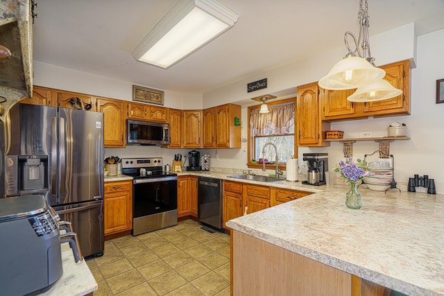 kitchen with light tile patterned floors, sink, kitchen peninsula, pendant lighting, and stainless steel appliances