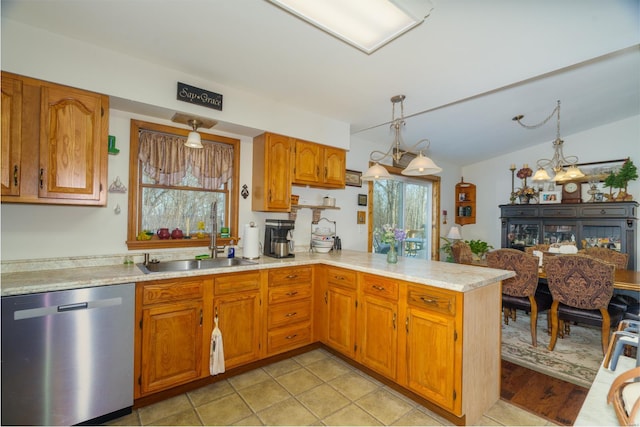 kitchen with stainless steel dishwasher, sink, kitchen peninsula, pendant lighting, and light tile patterned flooring