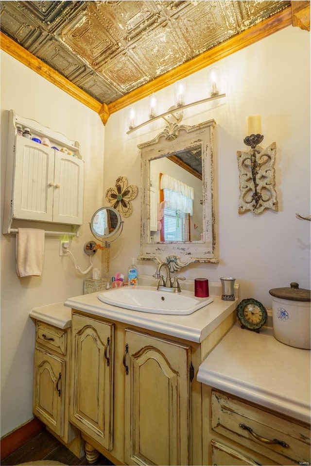 bathroom with crown molding and vanity