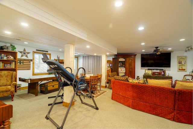 exercise room with ceiling fan and light colored carpet