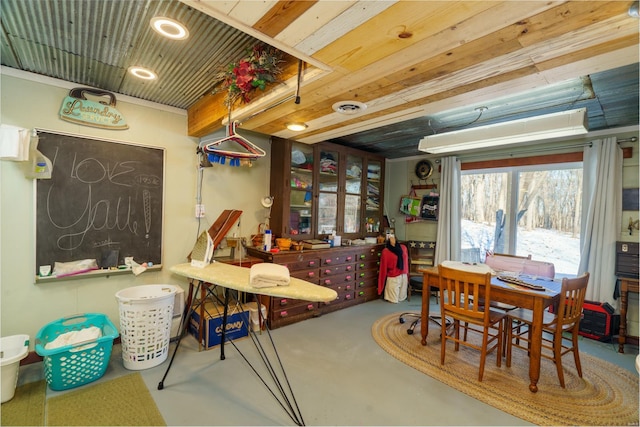 interior space with wooden ceiling and concrete flooring