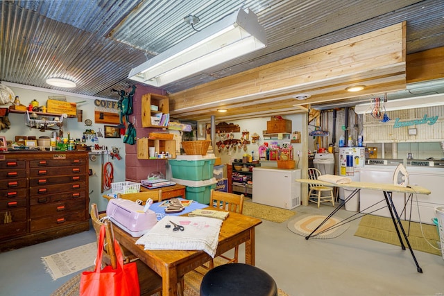 interior space featuring washing machine and dryer, refrigerator, and a workshop area