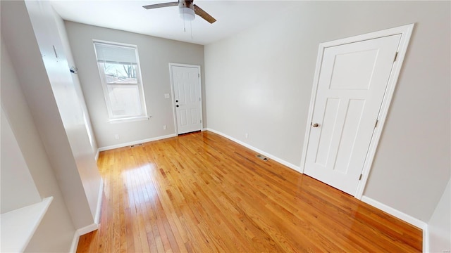 empty room featuring ceiling fan and light wood-type flooring