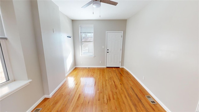 spare room with ceiling fan and light wood-type flooring