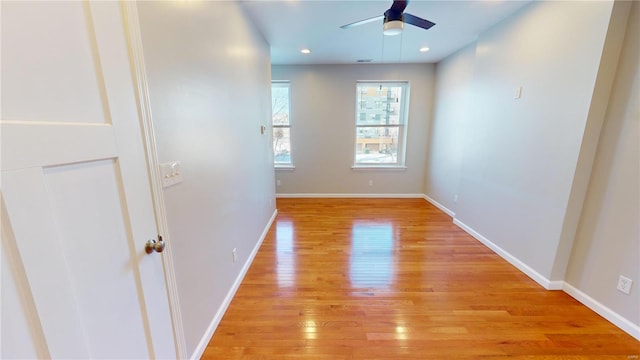 unfurnished room with ceiling fan and light hardwood / wood-style flooring