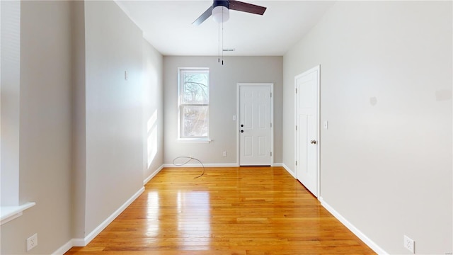 unfurnished room featuring ceiling fan, light hardwood / wood-style flooring, and a healthy amount of sunlight