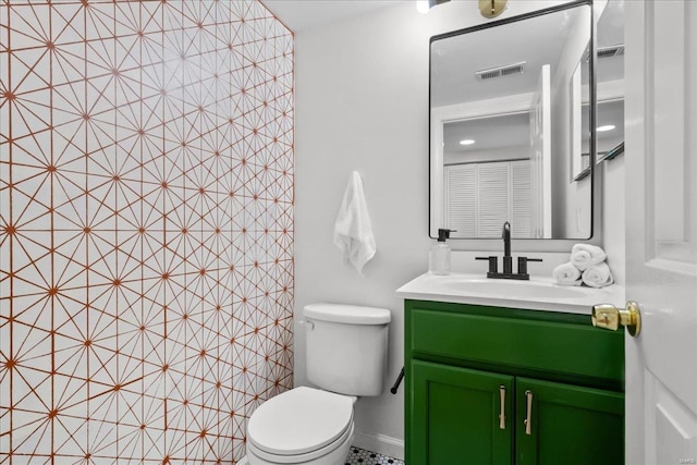 bathroom featuring tile patterned floors, vanity, and toilet