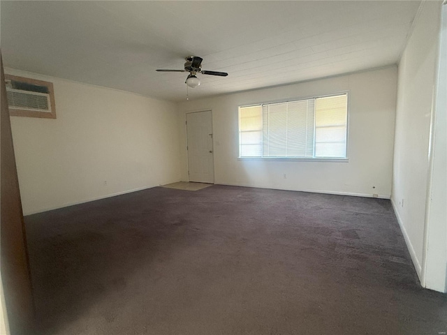 empty room featuring ceiling fan and dark colored carpet