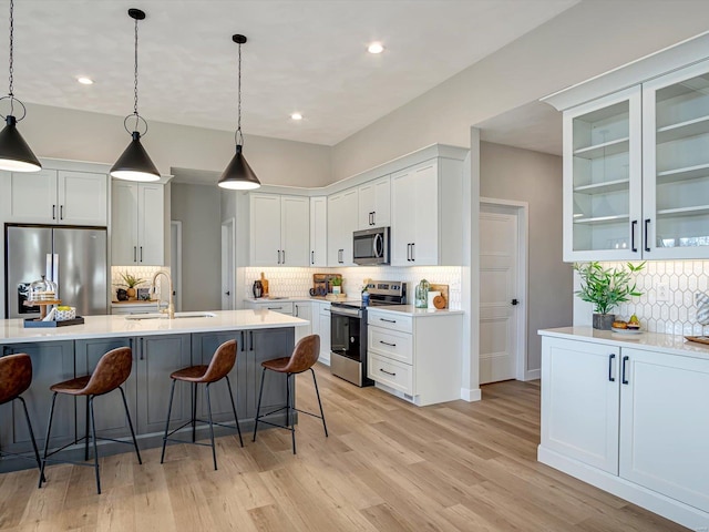 kitchen featuring pendant lighting, white cabinetry, appliances with stainless steel finishes, and sink