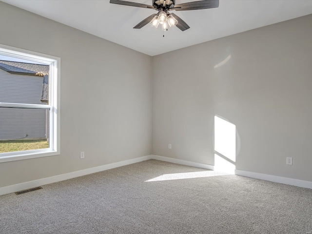 carpeted empty room featuring ceiling fan