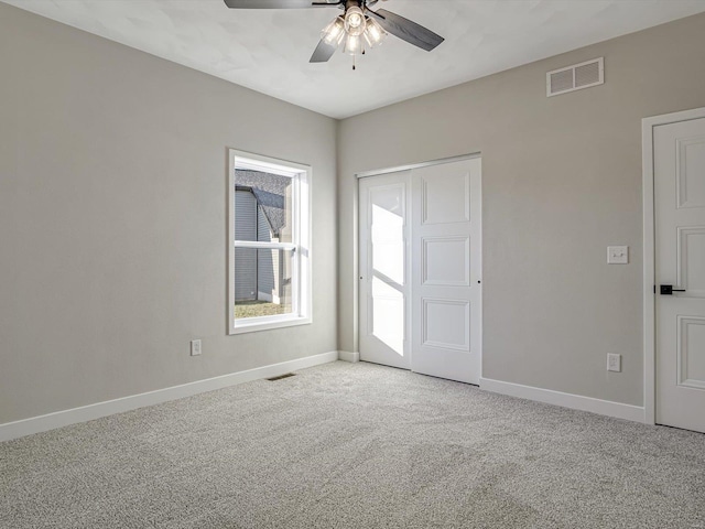 spare room with carpet and ceiling fan