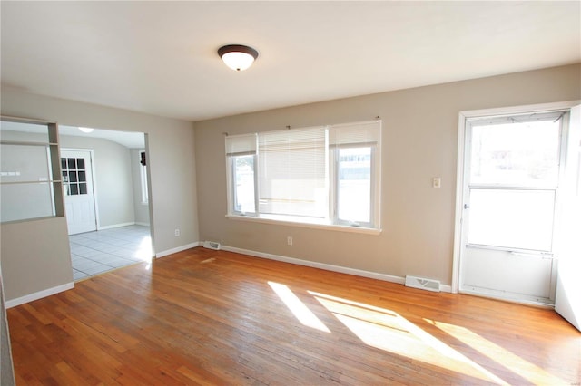 empty room with light hardwood / wood-style floors