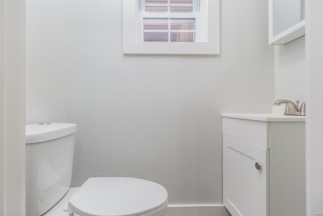 bathroom with toilet and vanity