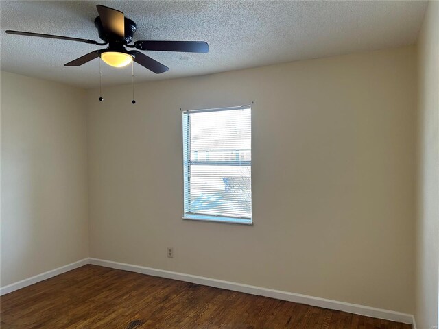 unfurnished room with ceiling fan and dark hardwood / wood-style flooring