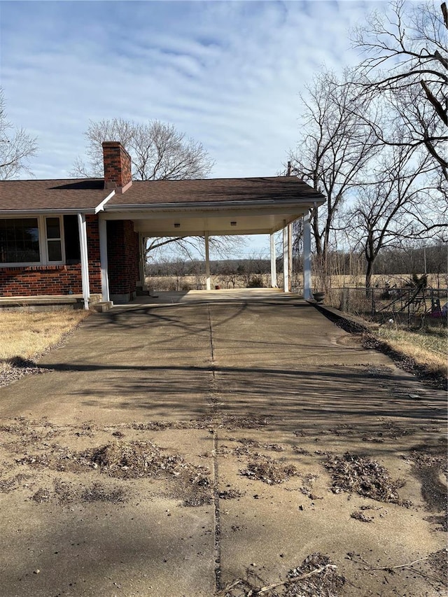 view of vehicle parking featuring a carport