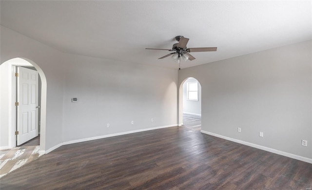 empty room featuring dark hardwood / wood-style flooring and ceiling fan