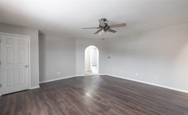 spare room with ceiling fan and dark wood-type flooring