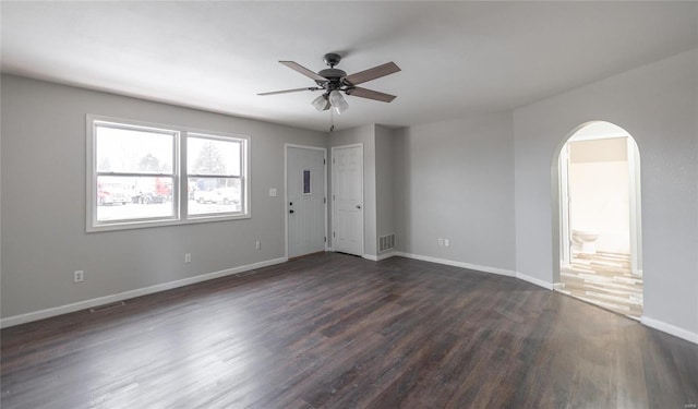 empty room featuring ceiling fan and dark hardwood / wood-style floors