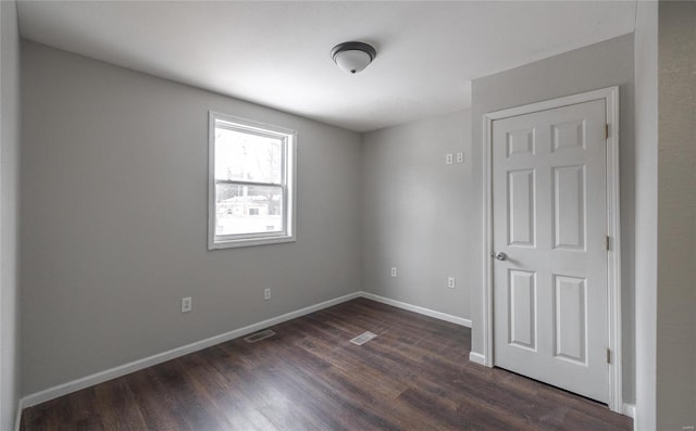 unfurnished room with dark hardwood / wood-style floors