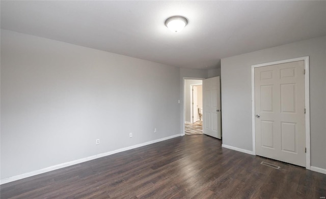 unfurnished bedroom with dark wood-type flooring