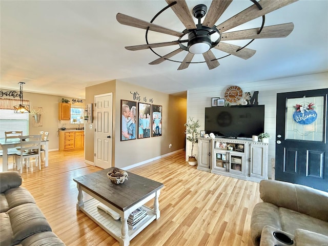 living room featuring light wood-type flooring and ceiling fan