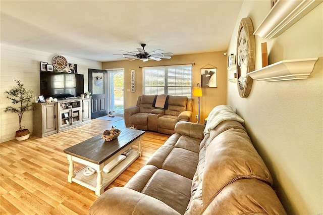 living room featuring ceiling fan and light hardwood / wood-style flooring