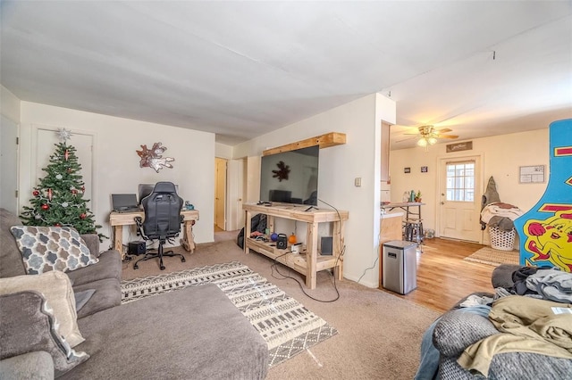 living room with ceiling fan and carpet flooring