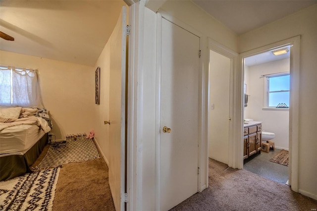 corridor featuring light colored carpet