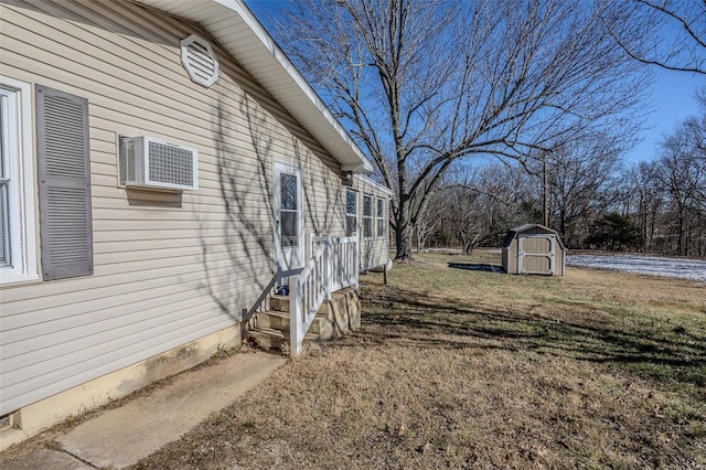 view of yard featuring a wall mounted air conditioner and a storage shed