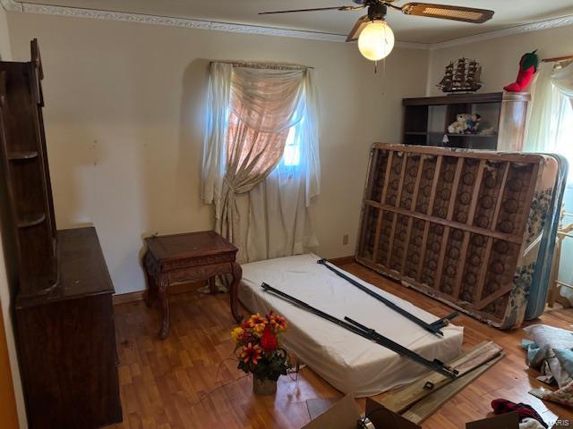 interior space with crown molding, hardwood / wood-style floors, and ceiling fan