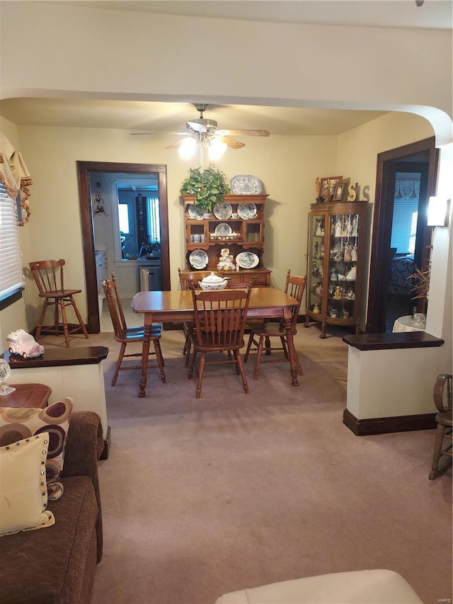 dining space featuring carpet floors and ceiling fan