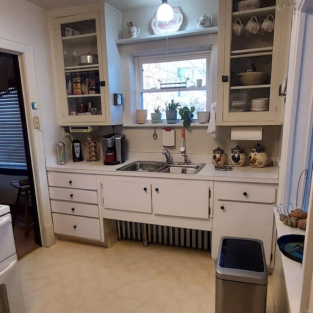 kitchen featuring sink and white cabinets