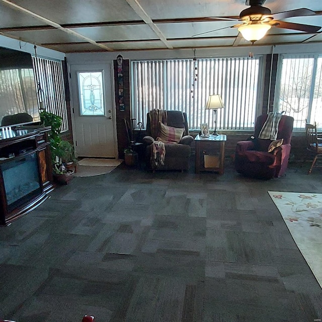 living room with ceiling fan and carpet